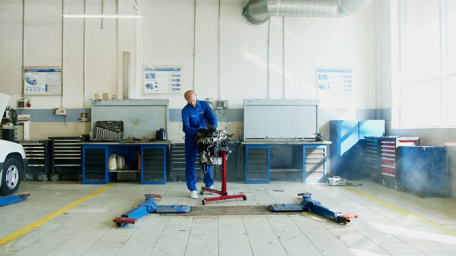 Mechanic inspecting a car engine in an auto repair workshop